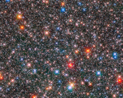 HST image of Milky Way Bulge Picture of a crowded field of stars some red, some blue of varying brightness